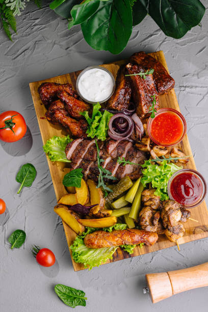 istock Assorted grilled meat and vegetable platter with sauces 2148692195