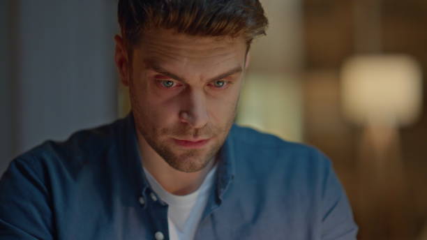 istock Tired freelancer working late at home closeup. Frowning man reading at evening 2148692226