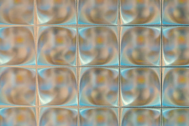 Small shiny square tiles, close-up. Unusual backgrounds and textures. Tiled design.