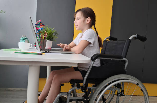 istock Little Girl in Wheelchair Using Laptop 2148692877