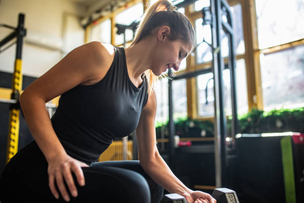 istock Woman exercising with dumbbell 2148694362