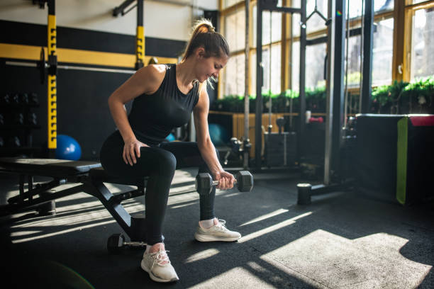 istock Woman exercising with dumbbell 2148694443