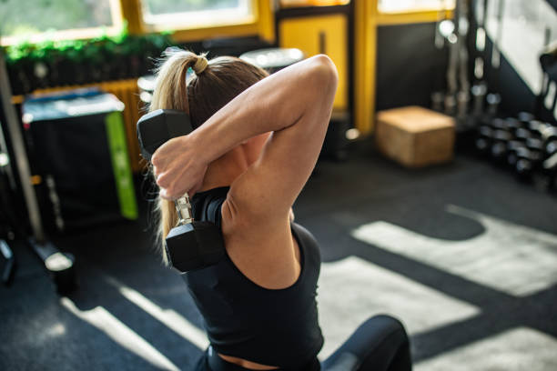 istock Woman exercising with dumbbell 2148694611