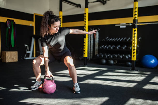 istock Woman exercising with kettlebell 2148695642