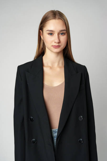 istock Young Woman in Black Jacket Posing to Camera against gray background 2148695738