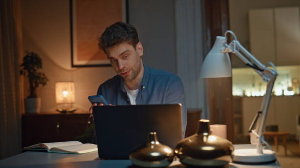 istock Busy freelancer virtual conference talking laptop computer at night home closeup 2148696035
