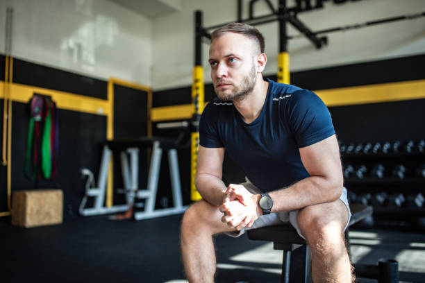 istock Fit man sitting in gym 2148696792