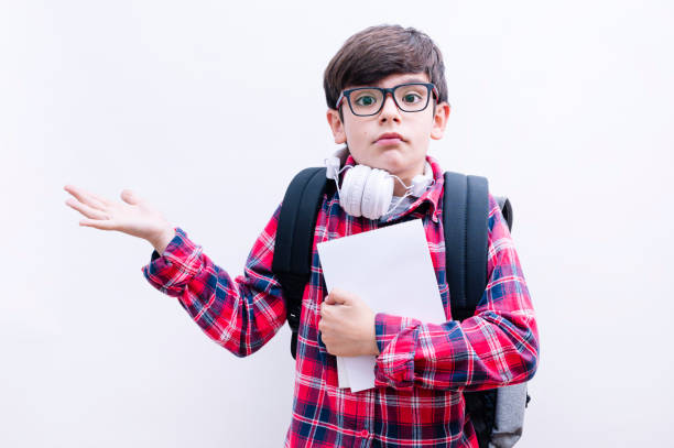 istock Beautiful student kid boy wearing backpack holding books over isolated white background 2148697743