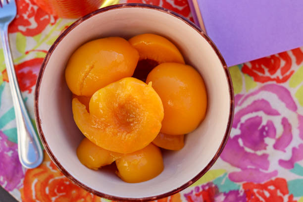 A bowl of fresh peaches on a table