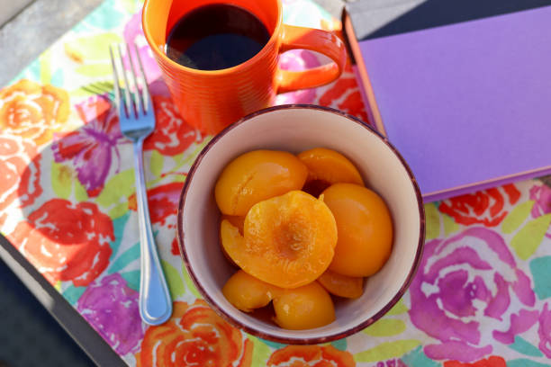 A bowl of fresh peaches on a table
