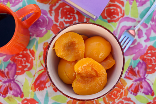 A bowl of fresh peaches on a table