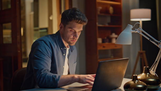 istock Serious accountant texting laptop night home closeup. Focused man writing notes 2148699510