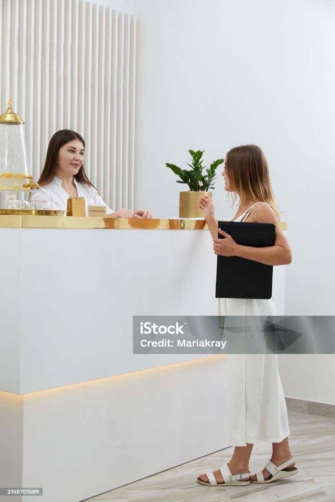 Reception Woamn Female Receptionist At Reception Desk With A Client In A Modern Office ...