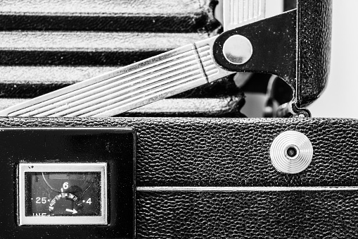 Dusty detailed black and white image of antique film camera