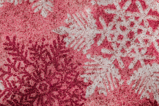 Winter snowflake pattern on red toned fabric