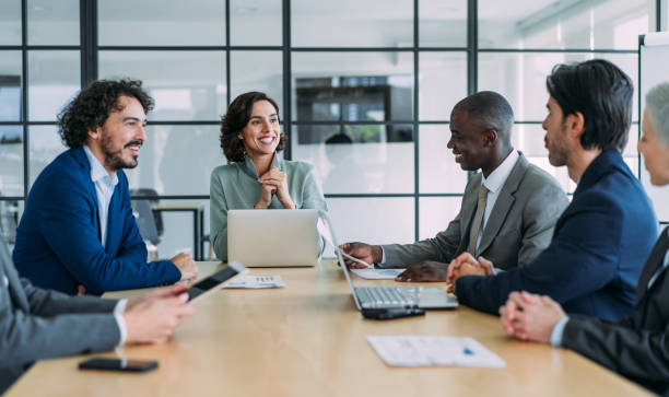 Business persons on meeting in the office. Group of business persons in business meeting. Group of entrepreneurs on meeting in board room. Corporate business team on meeting in the office. corporate business stock pictures, royalty-free photos & images