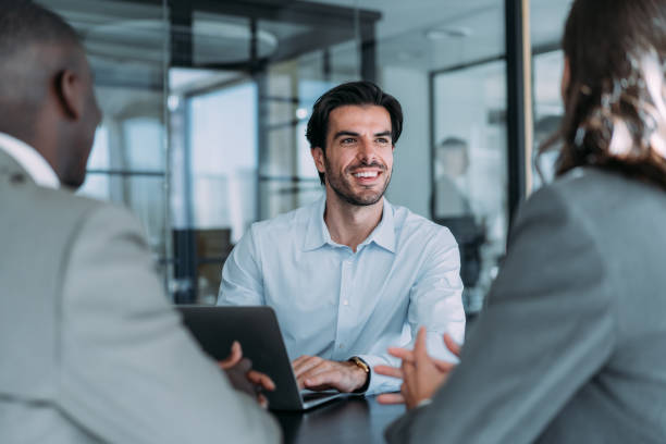Group of business persons talking in the office.