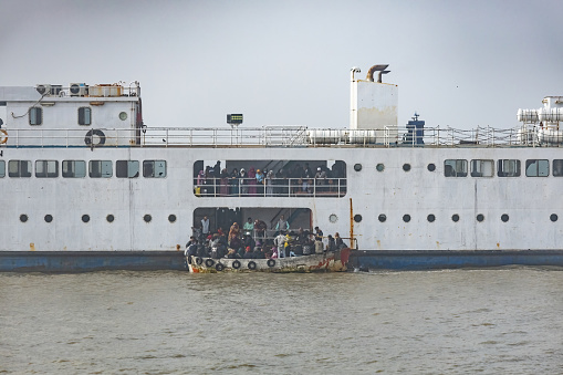 Passenger boat with people travelling by sea in Chittagong Bangladesh