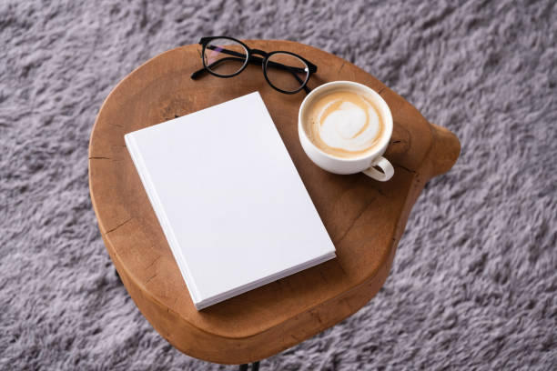 istock blank book mockup on coffee table with decorations and grey rug 2148706645