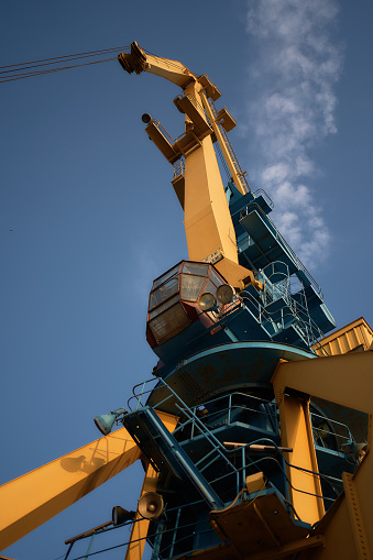 Burgas, Bulgaria - June 17, 2023:  crane in the port in Burgas at sunset