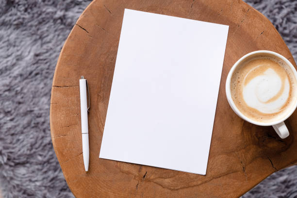 istock blank notepaper mockup on coffee table with cappuccino, pen and grey rug 2148706744