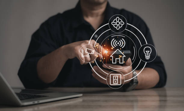 istock Concept smart home technology : businessman using mobile phone for touching or pressing the virtual screen for Remotely control home appliances using the internet system and AI. 2148706912
