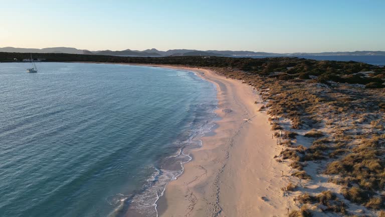 Espalmador beach, Formentera, at sunset. Ibiza and Es Vedra in the background.