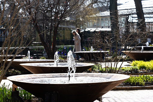 Fountain in public park on a sunny day. Copenhagen, Denmark - April 15, 2024