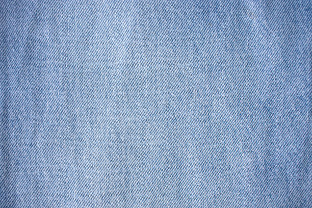 Blue denim texture, light jeans. Blue cotton canvas fabric texture as background