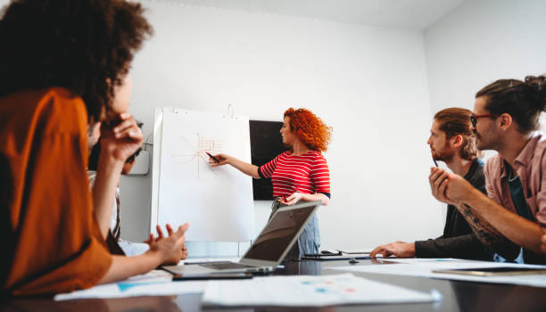 istock Smiling diverse colleagues gather in boardroom brainstorm discuss financial statistics together 2148708601