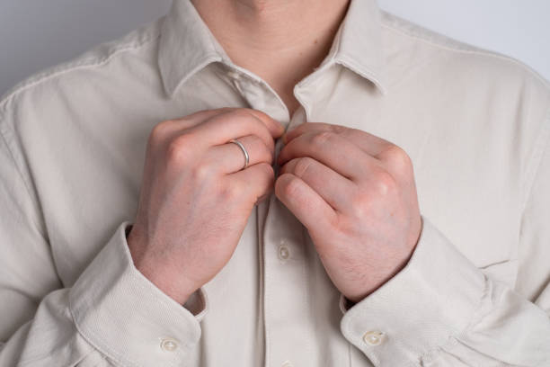 istock Handsome businessman buttoning his shirt sleeves and collar 2148710123