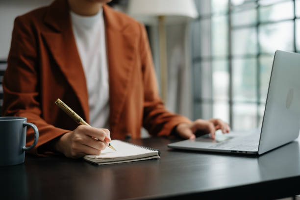 istock View of young professional businessman writing his idea concepts on notebook while working on his project 2148710829