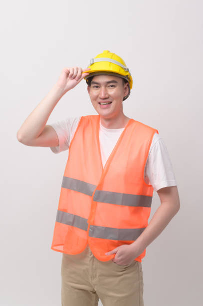 istock Portrait of male engineer wearing a protective helmet over white background studio. 2148710903