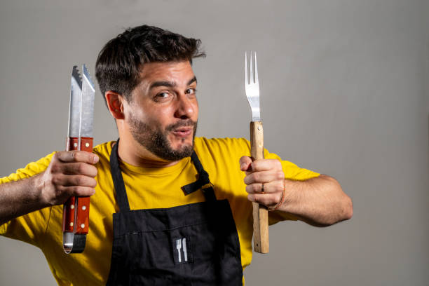 istock Young butcher with his utensils in his hand 2148711003