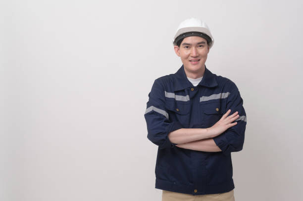istock Portrait of male engineer wearing a protective helmet over white background studio. 2148711104