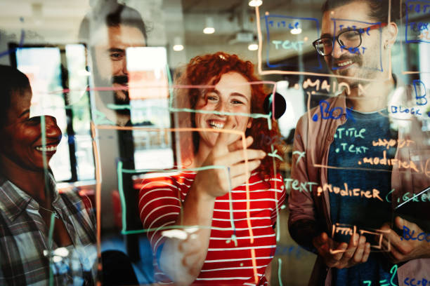 istock Group of business people and software developers working as a team in modern startup office 2148711618