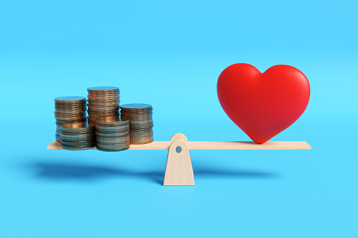 Stacks of gold coins and a red heart on each side of a wooden seesaw in blue background. Illustration of the concept of selection between wealth and romantic love