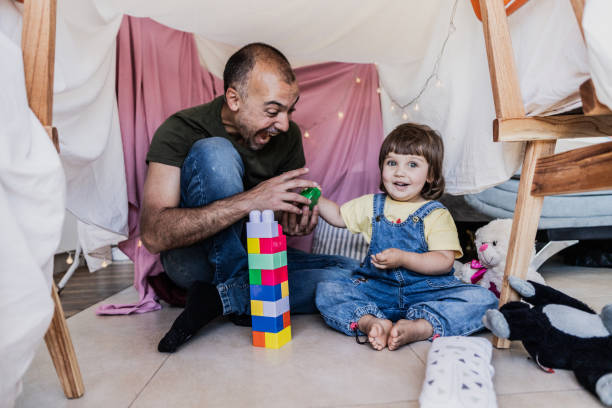 istock Father and daughter playing with blocks at home 2148717546