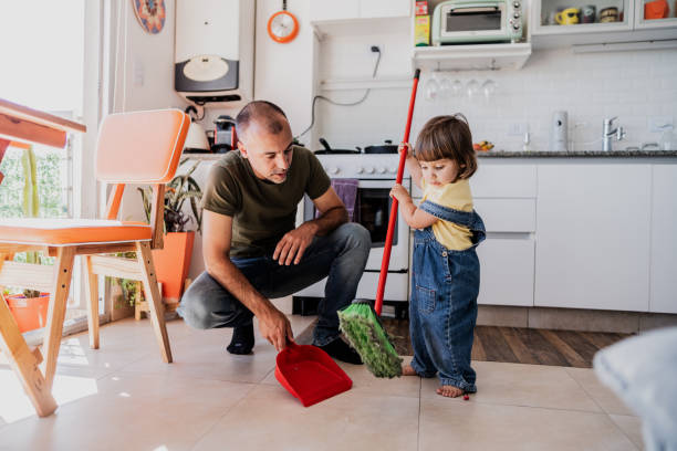 istock Father and daughter cleaning the kitchen at home 2148717631
