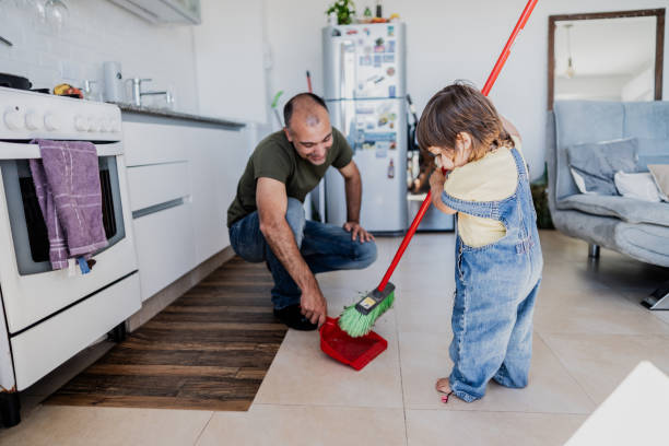 istock Father and daughter cleaning the kitchen at home 2148717632