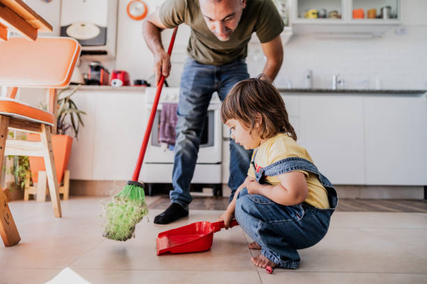 Father and daughter cleaning the kitchen at home