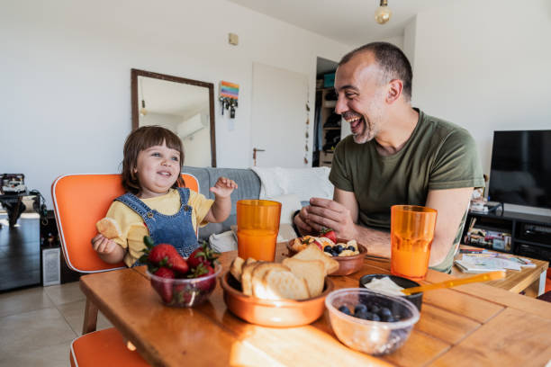 istock Father and daughter having fun at breakfast at apartment 2148717714