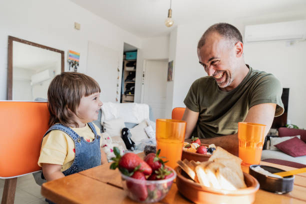 istock Father and daughter having fun at breakfast at apartment 2148717728