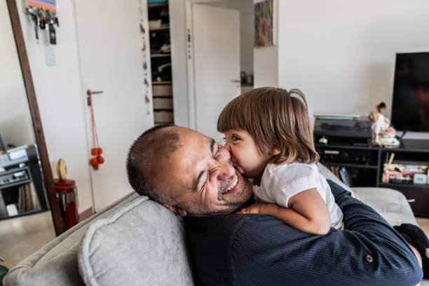 istock Father playing with daughter on sofa at home 2148717778