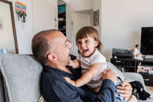 istock Father playing with daughter on sofa at home 2148717779