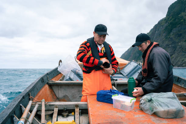 istock Fishermen drink coffee from a thermos on a boat 2148718407