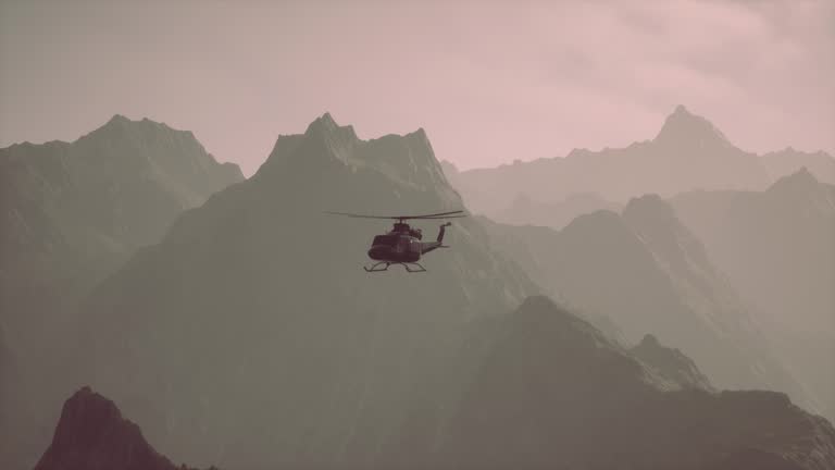 A helicopter is flying over a mountain range