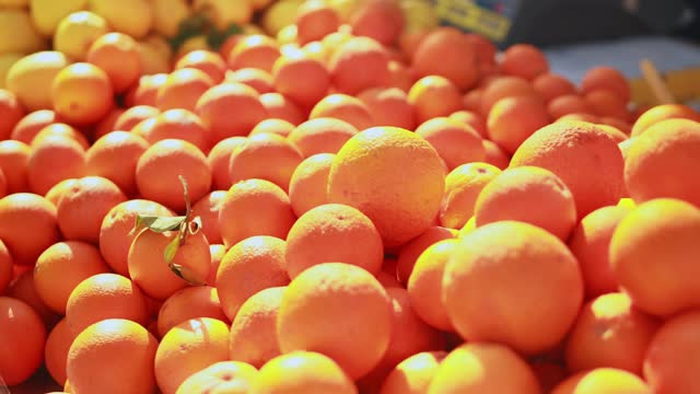 Close-up of fresh oranges in fruit store, pile of fresh oranges, orange is healthy fruit containing vitamin C.