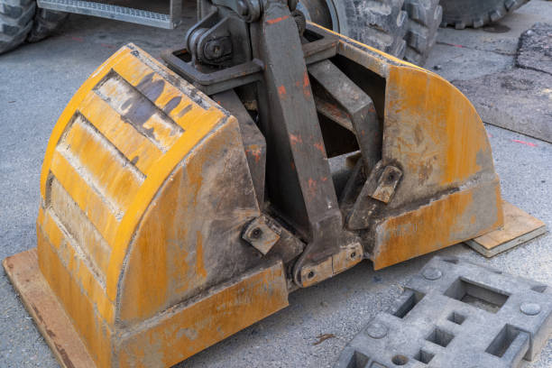 istock Excavator shovel on truck bed 2148722442