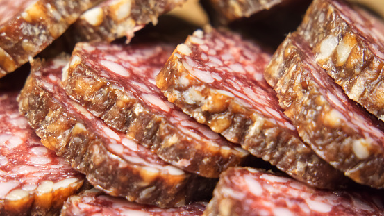 Chunks of dried sausage taken in close-up.